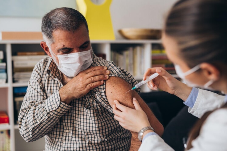 An adult being vaccinated